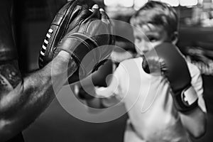 Boy Boxing Training Punch Mitts Exercise Concept photo