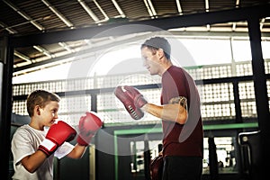 Boy Boxing Training Punch Mitts Exercise Concept photo