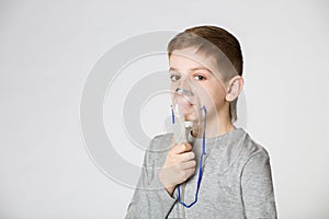 Boy breathing through inhalator mask photo