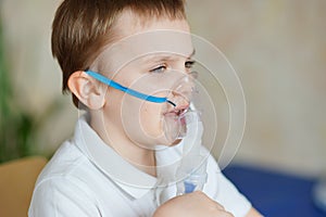 Boy breathing through inhaler. Nebulizer. At the doctor& x27;s. Healthcare and medical. Epidemic. Coronavirus