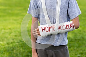 Boy with broken arm outdoors