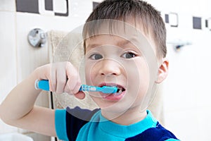 Boy brushing teeth, child dental care, oral hygiene concept, child portrait in bathroom with tooth brush