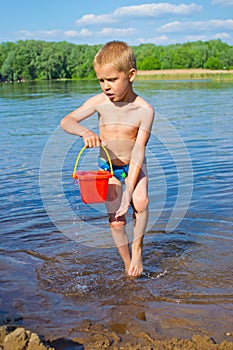 Boy with a bucket of water