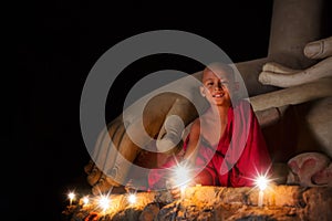 A boy in buddhism set fire with candle in bagan