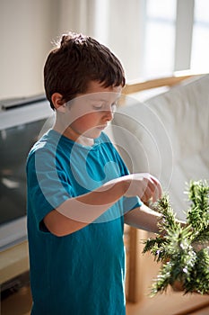 Boy building a Christmas tree