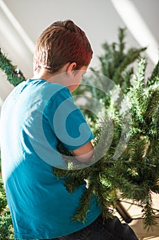 Boy building a Christmas tree