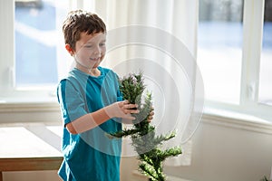 Boy building a Christmas tree