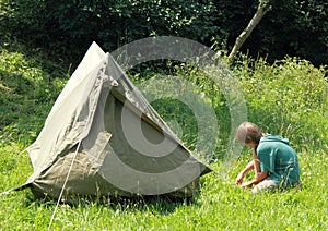 Boy building an old tent