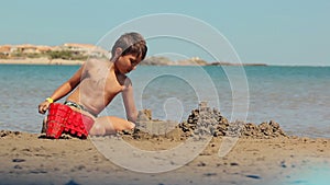 Boy is building a sand castles
