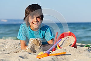 Boy building sand castles on the sea shore