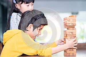 Boy building toy block tower with friend