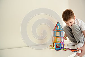 Boy building a toy rocket from blocks