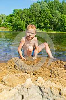 Boy builds a sand photo