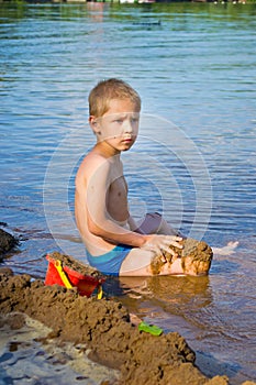 Boy builds a sand photo