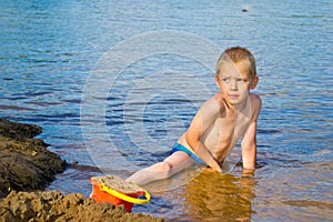 Boy builds a sand photo