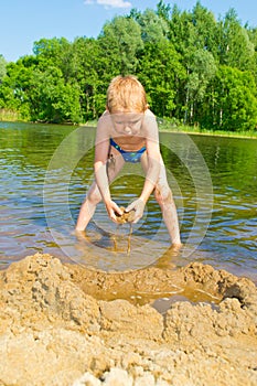 Boy builds a sand photo