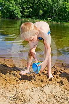 Boy builds a sand photo