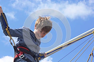 Boy bungee jumping on a trampoline