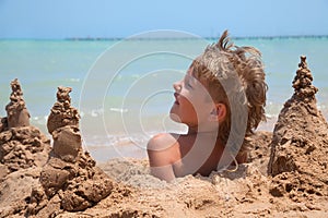 Boy buried in sand