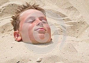 Boy buried in sand