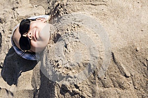 Boy buried in the sand