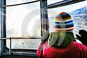 Boy in cable car looking out the window