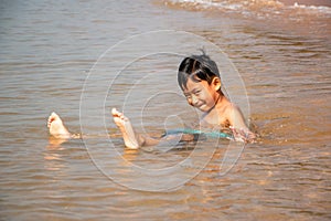 The boy came to play in the sea and happy soaking