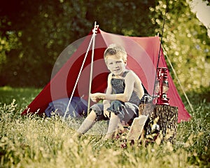 Boy camping with tent