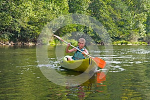 Boy canoeing on river