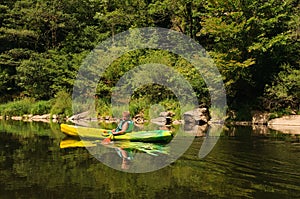 Boy canoeing on river