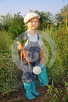 Boy with a carrot and a watering can