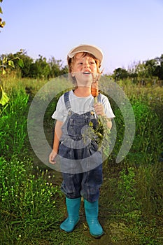 Boy with a carrot and a watering can