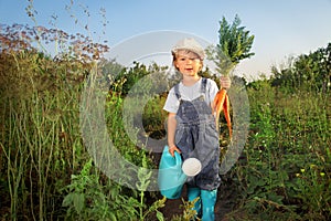 Boy with a carrot and a watering can