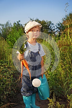 Boy with a carrot and a watering can