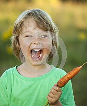 Boy with a carrot and a watering can