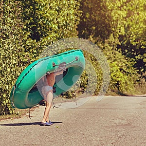 Boy carrying boat