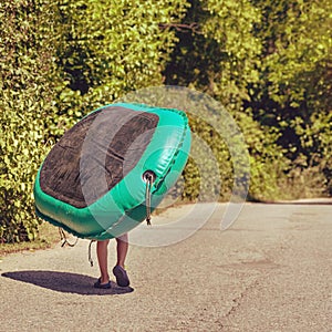 Boy carrying boat outdoor