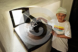 Boy in the castle with a cannon