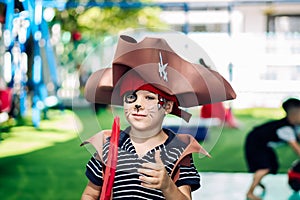 Boy Cat Pirate costume. Halloween party in kindergarten. Aqua makeup painted kids face. Bright festive