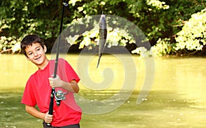 A boy catch a fish photo