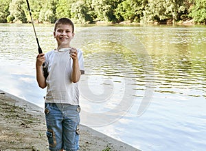 Boy catch fish on bait, child camping and fishing, river and forest, summer season