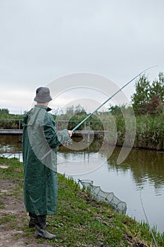 The boy is catching a net by the lake