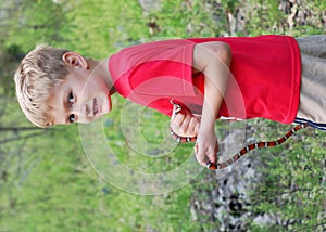 Boy catching wild snake