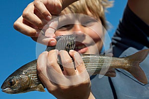 Boy caught grayling photo