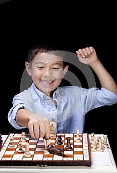 Boy celebrates chess win.