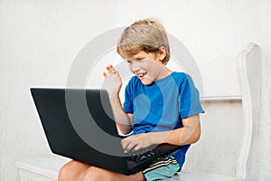 A boy chatting via laptop