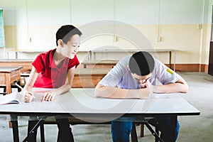 Boy cheating in the test by copying from the another boy