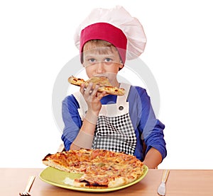 Boy chef eat pizza