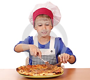 Boy chef eat pizza