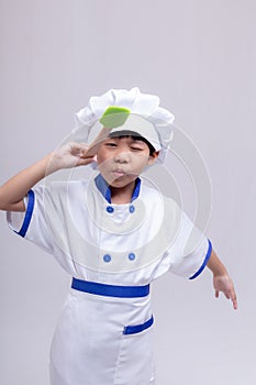 Boy in chef uniform on white background